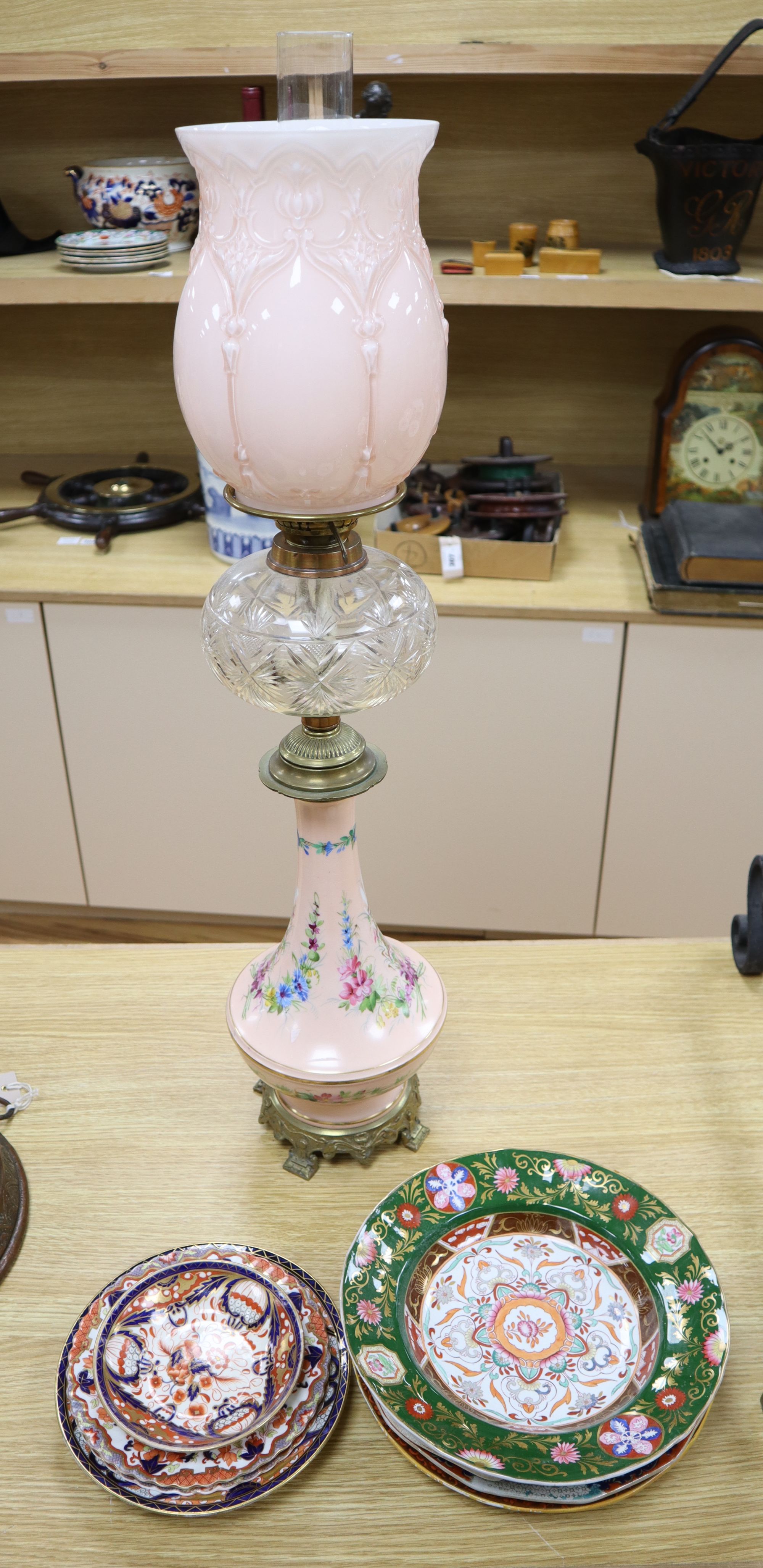 An ormolu mounted bone china oil lamp, height overall 80cm, an ironstone dessert dish and other tableware